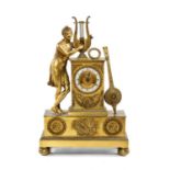 EMPIRE STYLE GILT METAL FIGURAL MANTEL CLOCK, with lyre and musician surmount on ornamented plinth