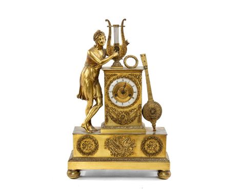 EMPIRE STYLE GILT METAL FIGURAL MANTEL CLOCK, with lyre and musician surmount on ornamented plinth base, on bun feet, white e