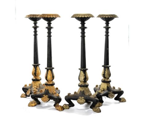 SET OF FOUR PARCEL-GILT, EBONISED & CAST IRON TORCHÈRES, gadrooned rims, reeded columns, leaf cast tripod base, lion's paw fe