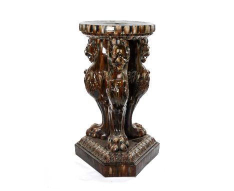 LARGE CONTINENTAL TREACLE GLAZED TERRACOTTA JARDINIÈRE STAND, three leopard monopodia to canted triangular base, 95cms (h)Com