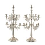POLISHED METAL NINE-LIGHT CANDELABRUM, scrolled branches arranged in two tiers, on circular foot,