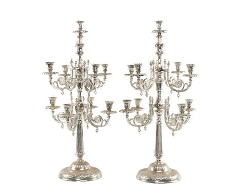 POLISHED METAL NINE-LIGHT CANDELABRUM, scrolled branches arranged in two tiers, on circular foot, 82cms (h)Provenance: The Co
