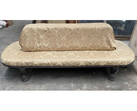 REGENCY STYLE EBONISED OVAL SOCIABLE SETTEE, padded back and all around seat, on carved frame and scrolled lion's paw feet, H