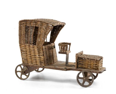 ANTIQUE WICKER TOY AUTOMOBILE, with rear cast iron wheels, 52cms (l)Comments: replaced front axle and wheels, missing steerin