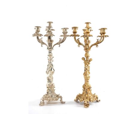 PAIR OF POLISHED WHITE METAL SEVEN-BRANCH CANDELABRAS, figural columns on Rococo tripod bases, one later painted, 71cms (h)Pr