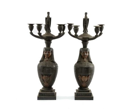 PAIR OF PATINATED BRONZE EGYPTIAN REVIVAL FIVE-LIGHT CANDELABRA, with stork finials above canopic jar bases, on stepped plint