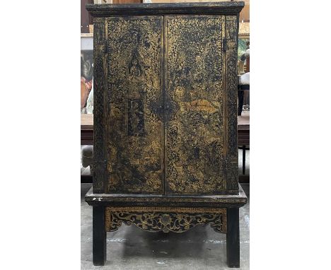 THAI BLACK AND GOLD LACQUER MANUSCRIPT CABINET, tapering form, painted red interior with shelves, 156 (h) x 96 (w) x 78cms (d