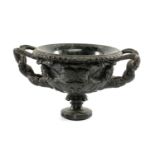 CARVED GREEN SERPENTINE MODEL OF WARWICK VASE, intertwined handles, on socle base, 33cms (w)
