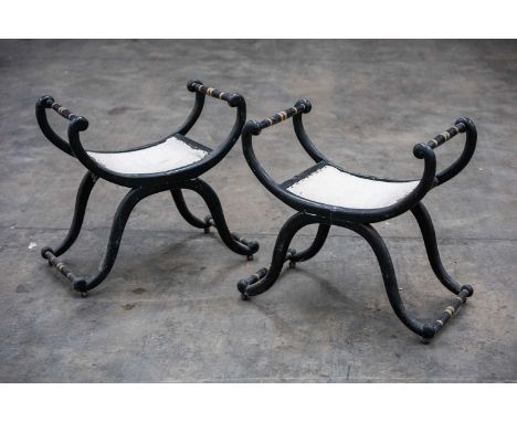 PAIR OF REGENCY STYLE EBONISED & PARCEL-GILT X-FRAMED STOOLS, scrolled frame joined by turned stretchers, 58 (h) x 60 (w) x 3