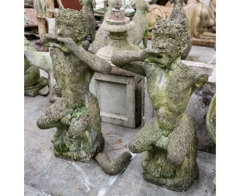 PAIR OF RECONSTITUTED STONE FIGURES OF PAN, seated on tree stumps playing pipes, 98cms (h)Comments: both with damaged arms, l