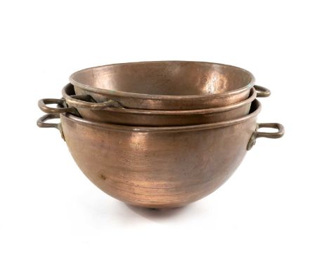 THREE GRADUATED COPPER COOKING BOWLS, rounded bottoms, with riveted copper handles, largest 56cms (diam.) (3)Provenance: The 
