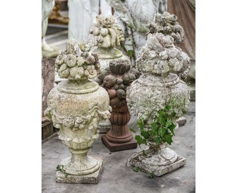 GROUP OF RECONSTITUTED STONE URNS, comprising set of four painted urns with floral finials, 80cms (h), and another smaller, p