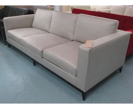 SOFA, three seater, in neutral ribbed fabric on ebonised supports, 238cm L.