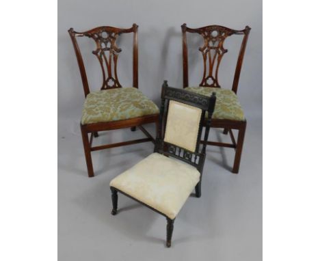 A pair of Chippendale style mahogany single dining chairs, with drop in seats, and a Victorian ebonised nursing chair, (3).
