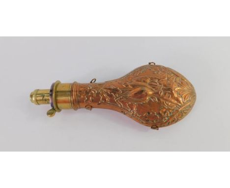 A Victorian copper and brass shot flask, with embossed decoration of hanging game and foliage, gram measure to neck, 21cm lon