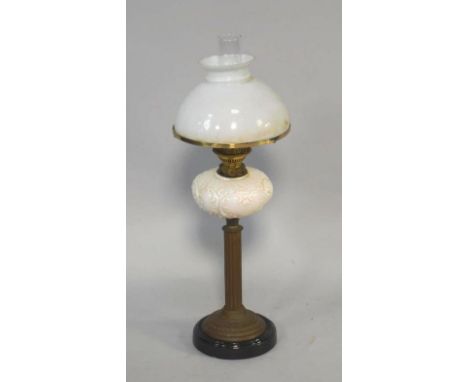 A Duplex late 19thC brass oil lamp, of fluted column form on a black glass socle base, with a rococo foliate scroll moulded m