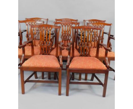 A set of eight Chippendale style mahogany carver dining chairs, with red foliate drop in seats, raised on square legs united 