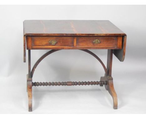 A yew wood veneered sofa table in the Regency style, fitted with two drawers and with bobbin turned stretcher and plain taper