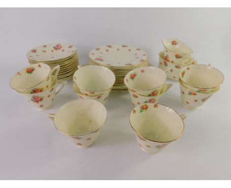 A Royal Doulton porcelain part tea service decorated with roses, early 20thC, comprising pair of bread plates, cream jug, sug