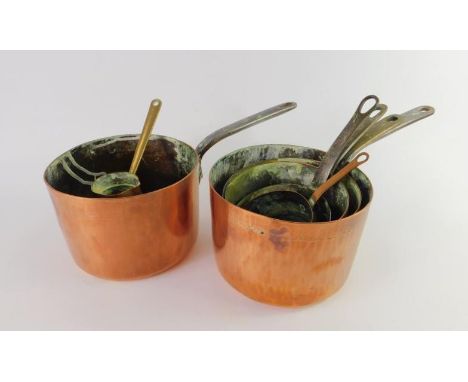 Victorian copper saucepans with iron handles, together with a copper jug measure ladle with a brass handle, (7).