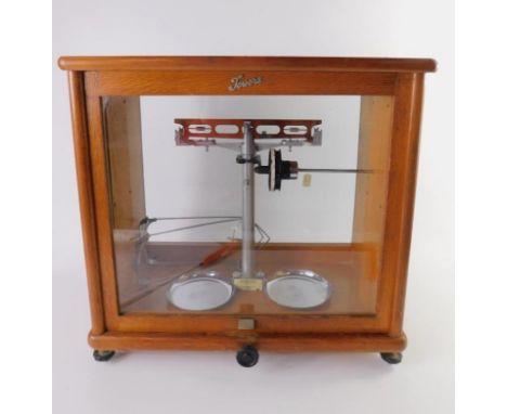 A set of J W Towers & Co Ltd precision chemical balance scales, oak cased, 42cm x 22cm x 40cm.
