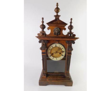 A Continental late 19thC walnut and pine mantel clock, brass circular dial with enamel chapter ring bearing Roman numerals, e