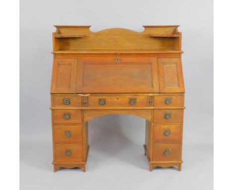 A Victorian oak clerk's bureau, The Britisher Desk, the top with two corner shelves, over a fall flap enclosing two drawers a