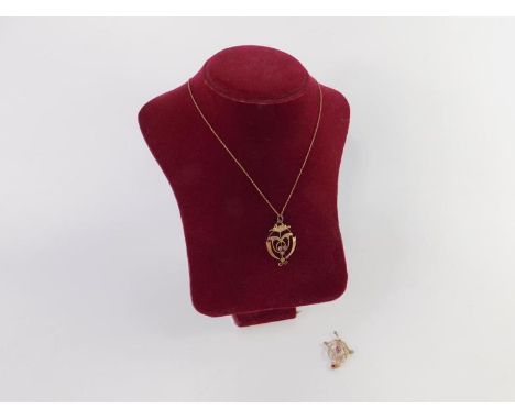 An Edwardian pink tourmaline and seed pearl pendant, set in yellow metal, marked 9ct, and a further tourmaline set pendant on