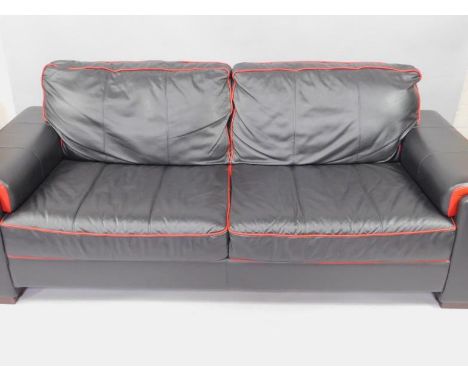 A black leather two seater sofa, with red leather trim, 223cm long.