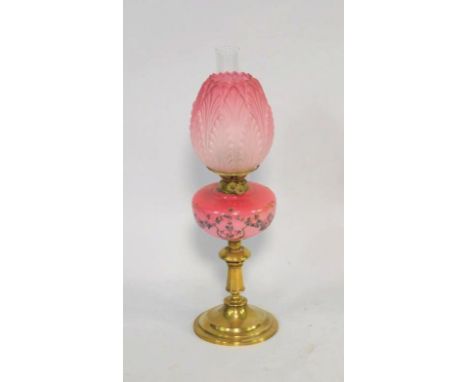 A Duplex late 19thC brass oil lamp, of turned and stepped form with a pink opaline glass reservoir with painted floral decora