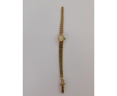 A Rotary lady's 9ct gold cased wristwatch, oval silvered dial, on a 9ct gold textured gold strap, 16.2g.