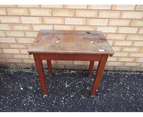 A vintage wooden school desk with hinged top and inkwell recess, approximately 59 cm x 61 cm x 39 cm
Items must be paid for a