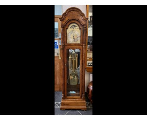 Howard Miller Oak Cased Grandfather Clock, with gilt and silver dial, glazed front, mirrored back with free weights and pendu