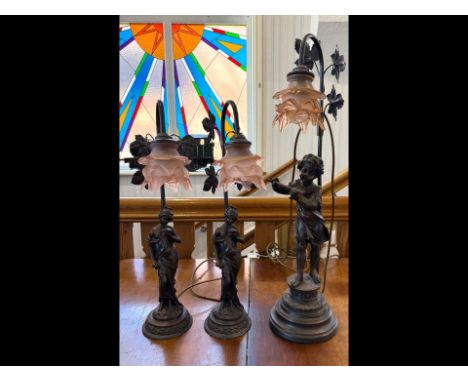 Three Decorative Spelter Lamps - Decoration with damsels and young girls playing flute. With 3 glass pink/peach shades. Highe