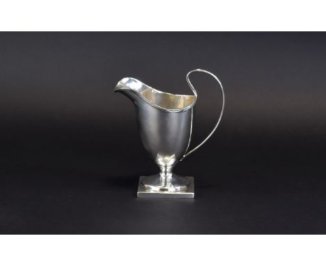 Victorian  - Late Helmet Shaped Milk Jug with Reeded Borders Raised on a Square Base. Hallmark Chester 1886, Makers C.N - R.B