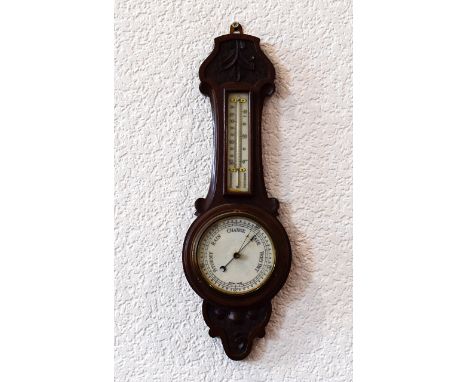 Barometer Small dark wood barometer with carved detailing, marked 'British made' to dial. Floral carving to bottom, acanthus 