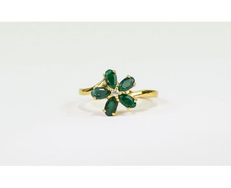 Emerald and White Topaz Flower Ring, five oval cut emeralds, mined in Brazil, centred by a round cut white topaz, totalling 1