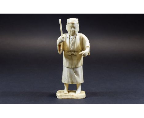 Chinese Ivory Figure of a Man about to hit a fish with a stick; mounted on a bone base; 6 inches high