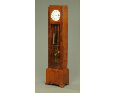 A walnut cased longcase clock, circa 1950, twin weight striking on gongs, with glazed doors and raised on short bracket feet.