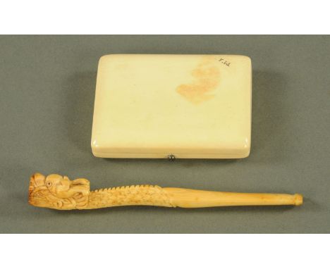 A Chinese carved ivory cheroot holder, early 20th century, carved as a dragons head with part scale body, 14 cm long, togethe