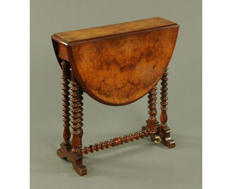 A Victorian walnut Sutherland table, small proportions, upon bobbin turned legs and stretchers and with white ceramic castors