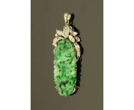 A Chinese 18 ct white gold mounted carved jade pendant, stamped "18 K".  Height 52 mm, width 20 mm (see illustration). 
