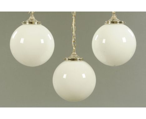 Three milk glass ceiling light globes, 20th century.  Diameter +/- 25 cm. 