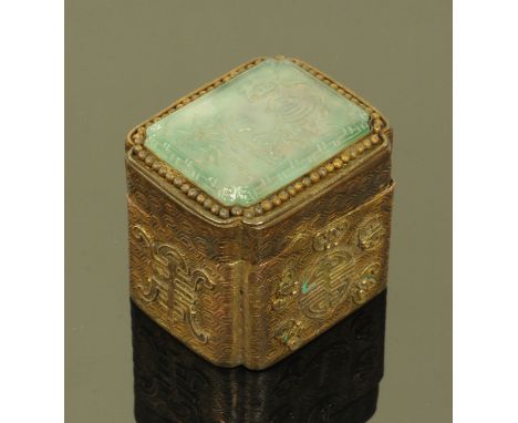 A Chinese gilt metal box, with jade panel to the top depicting a kingfisher and bamboo.  40 mm x 32 mm x 35 mm.  CONDITION RE