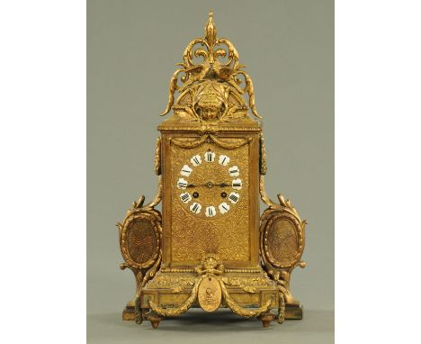 A 19th century ormolu mantle clock, French, with ceramic tablet numerals.  Height 42 cm, width 25 cm.  CONDITION REPORT: The 