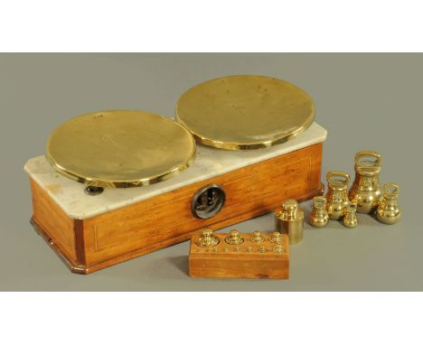A set of French shop scales, 19th century, with brass pans stamped with letters of the alphabet upon a marble and inlaid wood