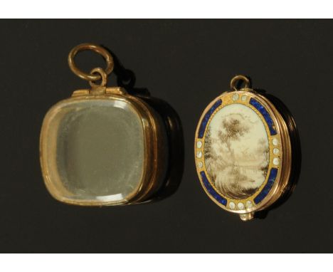 A Georgian miniature enamel memorial locket, handpainted with monochrome rural landscape in a gilt metal and blue enamel bord