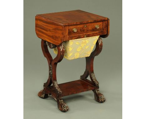 A William IV mahogany worktable with drop flaps, above a single drawer with embossed brass handles in turn above a sewing bag