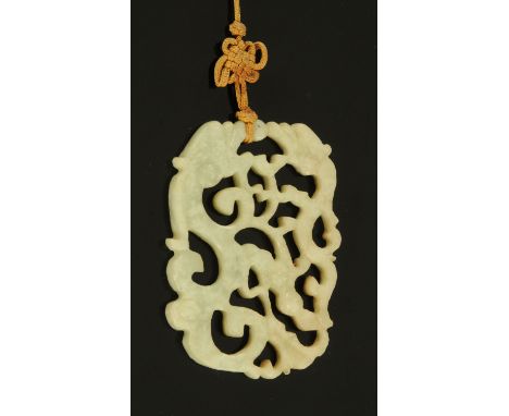 A Chinese carved stone dragon pendant, 20th century, of rectangular form and carved on both sides with two archaic style drag