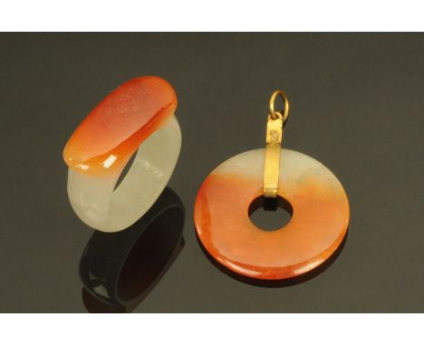 A Chinese brown and white jade pendant, with similar ring, size N/O. CONDITION REPORT: The pendant has very small fleabite ni